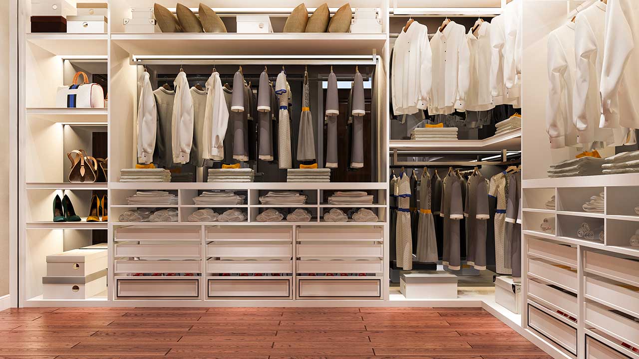 Organized closet with labeled bins, hanging organizers, and color-coordinated clothes