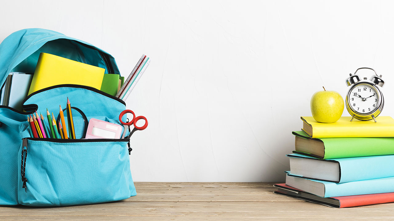 Back to school supplies including notebooks, pencils, and folders from the dollar store