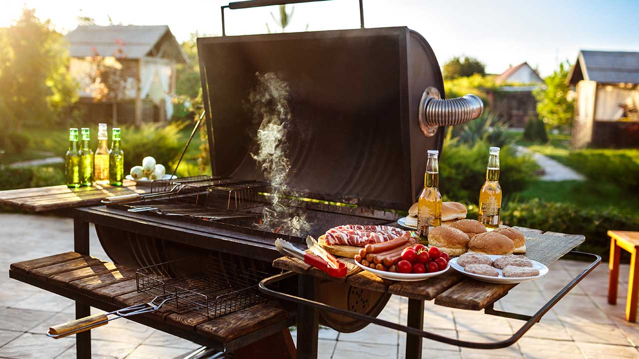 Backyard BBQ setup with dollar store grilling tools and colorful tableware