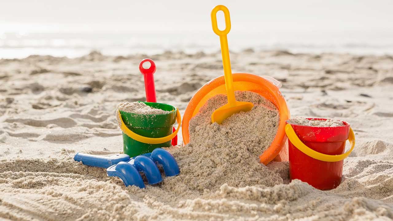 Colorful summer bucket filled with toys and crafts from dollar store